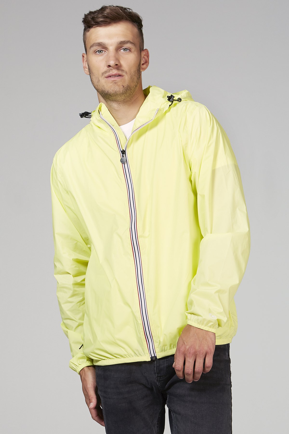 Citrus full zip packable rain jacket displayed on a hanger, showcasing its vibrant color and compact design.