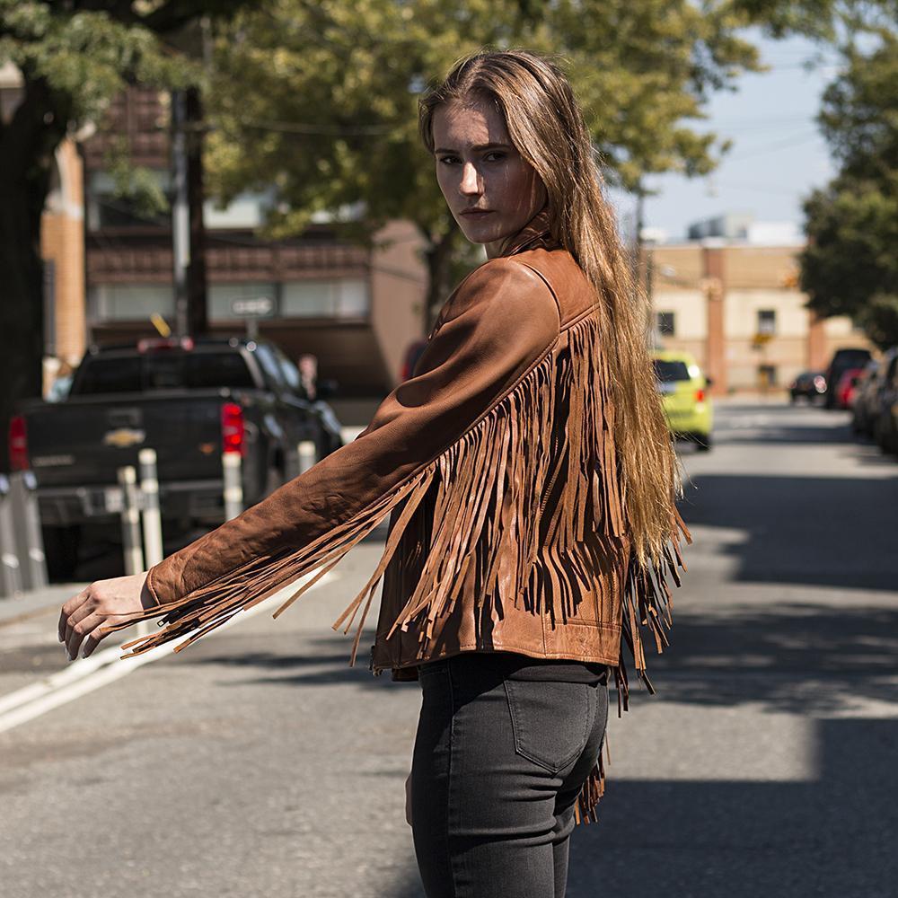 Daisy Women's Leather Jacket featuring fringe details and an asymmetrical collar in black, whiskey, and oxblood colors.