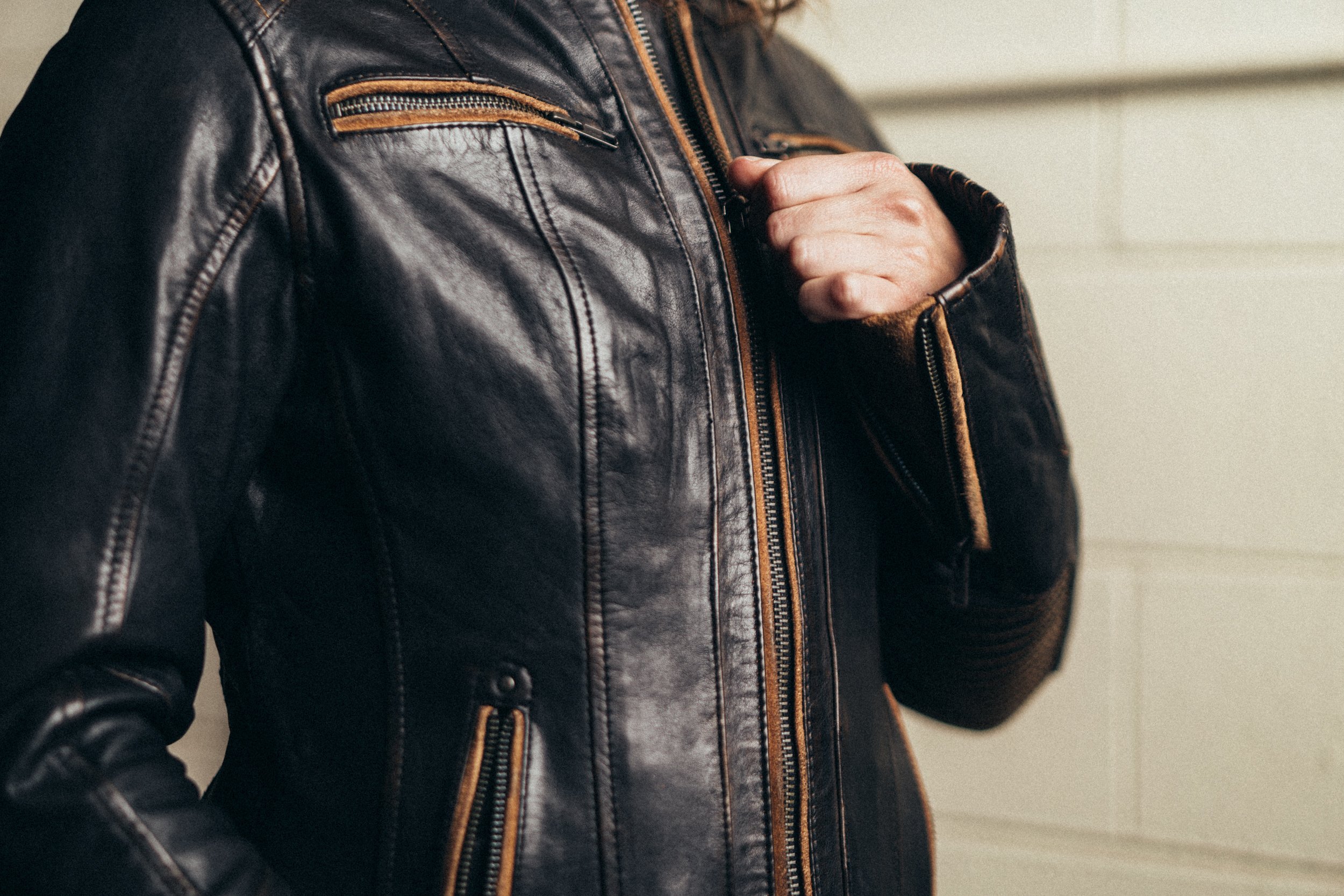 Electra Women's Leather Motorcycle Jacket featuring a stylish scooter design, banded collar, and multiple pockets for functionality.