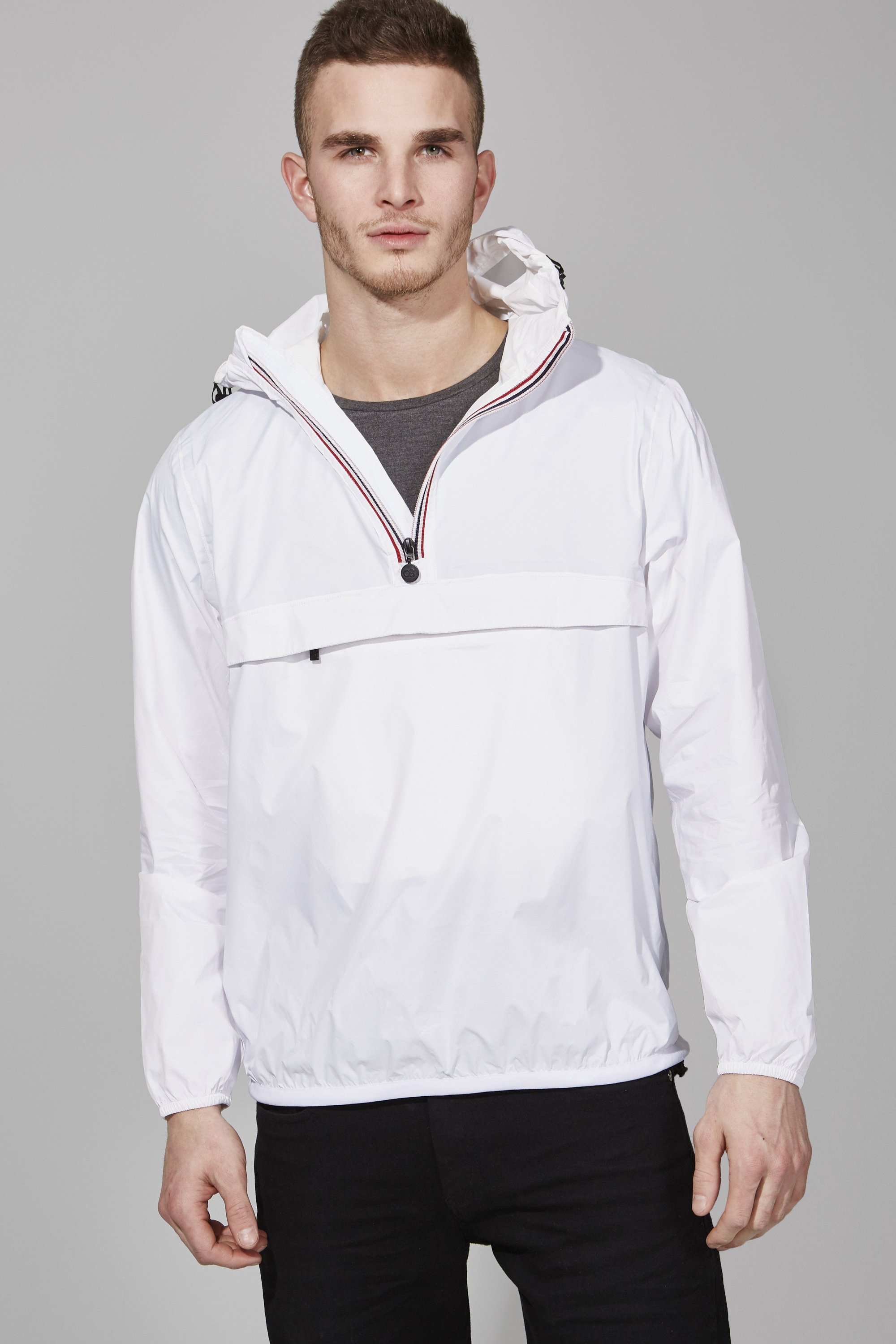 White quarter zip packable rain jacket with heat-sealed seams, designed for waterproof and breathable protection.