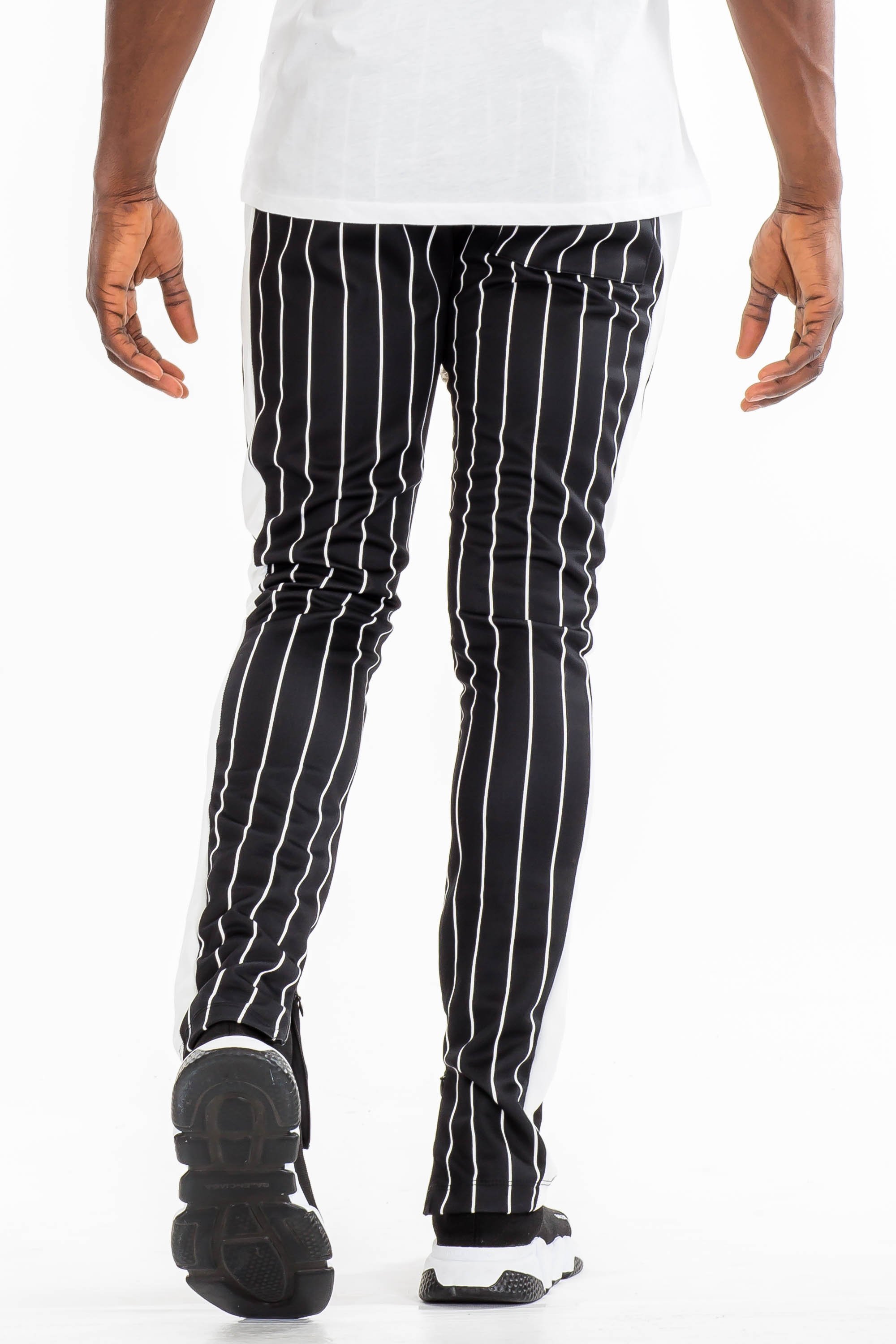 A pair of stylish pin stripe track pants featuring a skinny fit, elastic waistband with drawstring, and standard pockets, displayed on a neutral background.