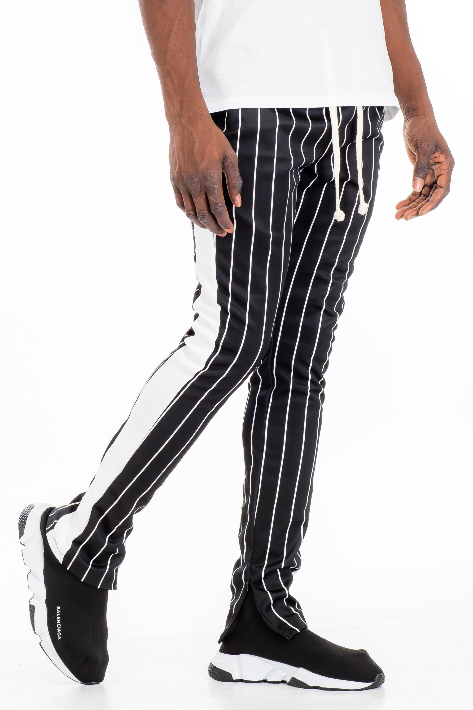 A pair of stylish pin stripe track pants featuring a skinny fit, elastic waistband with drawstring, and standard pockets, displayed on a neutral background.