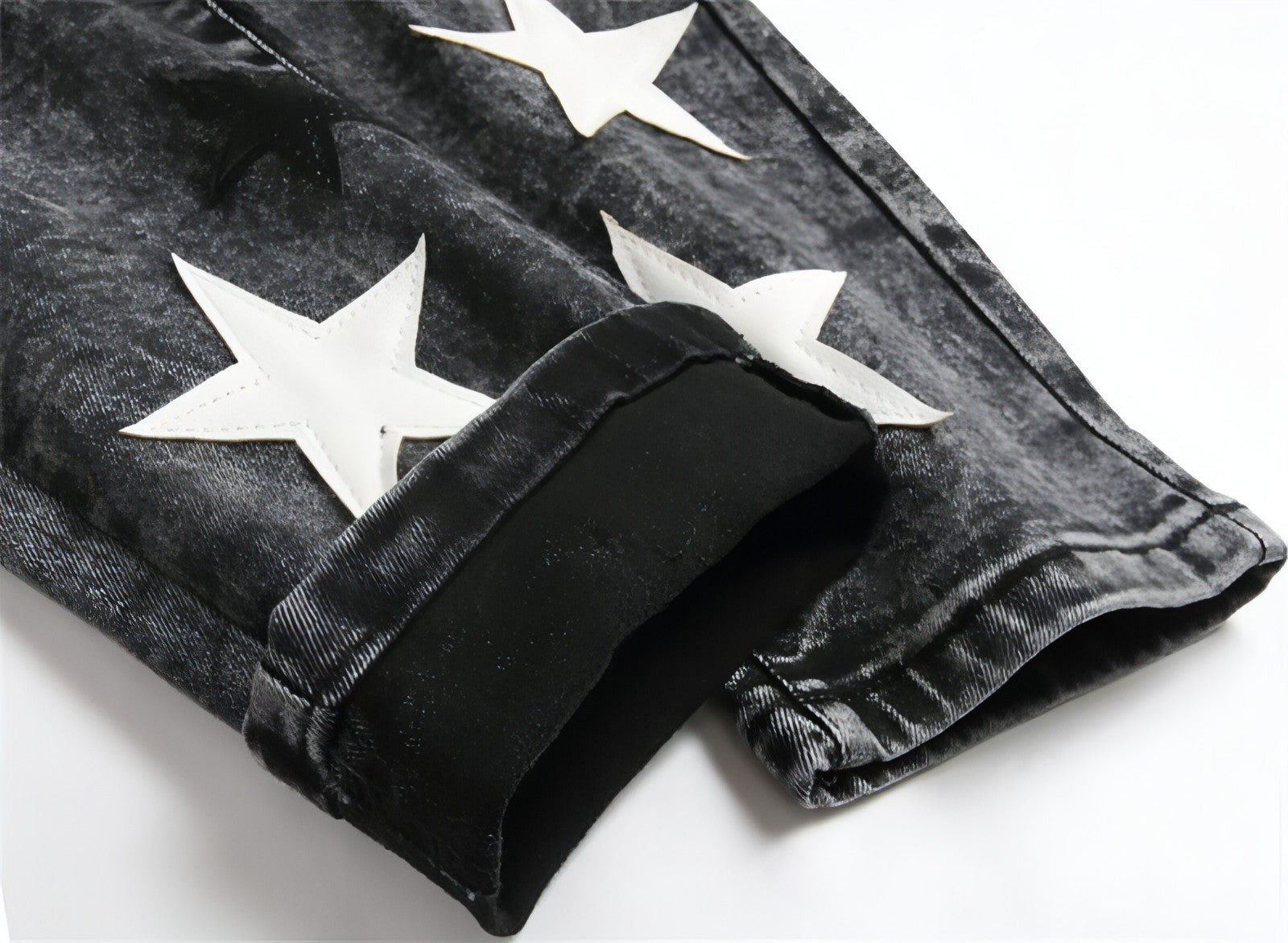 Punk men's jeans featuring unique hole embroidery and five-pointed star detailing, showcasing a rebellious style.
