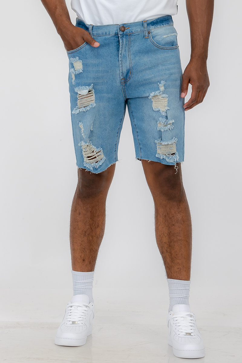 Men's distressed denim shorts featuring a button closure waist and standard pockets, styled above the knee for a trendy summer look.