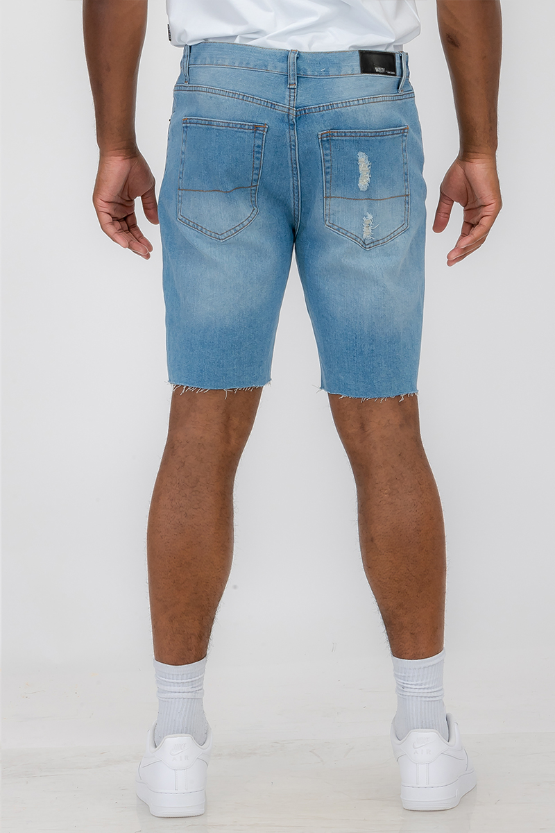 Men's distressed denim shorts featuring a button closure waist and standard pockets, styled above the knee for a trendy summer look.