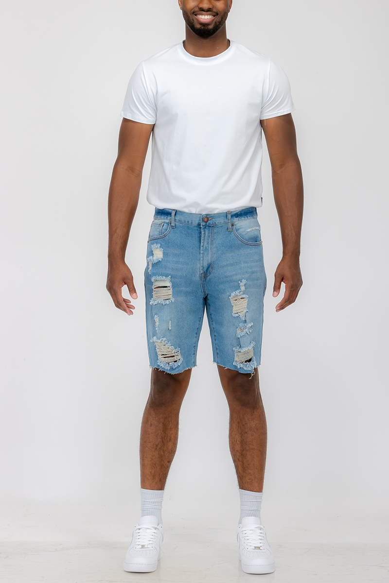 Men's distressed denim shorts featuring a button closure waist and standard pockets, styled above the knee for a trendy summer look.