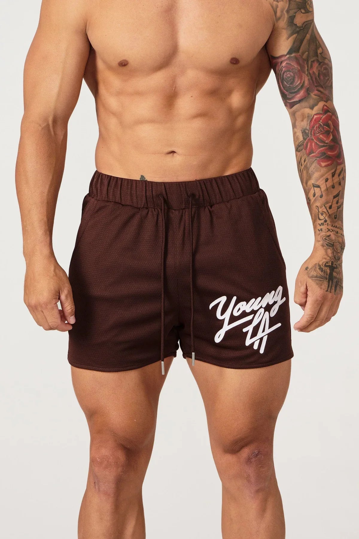 Young LA Trendy Beach Shorts for men featuring vibrant prints and elastic waist for comfort, perfect for summer activities.