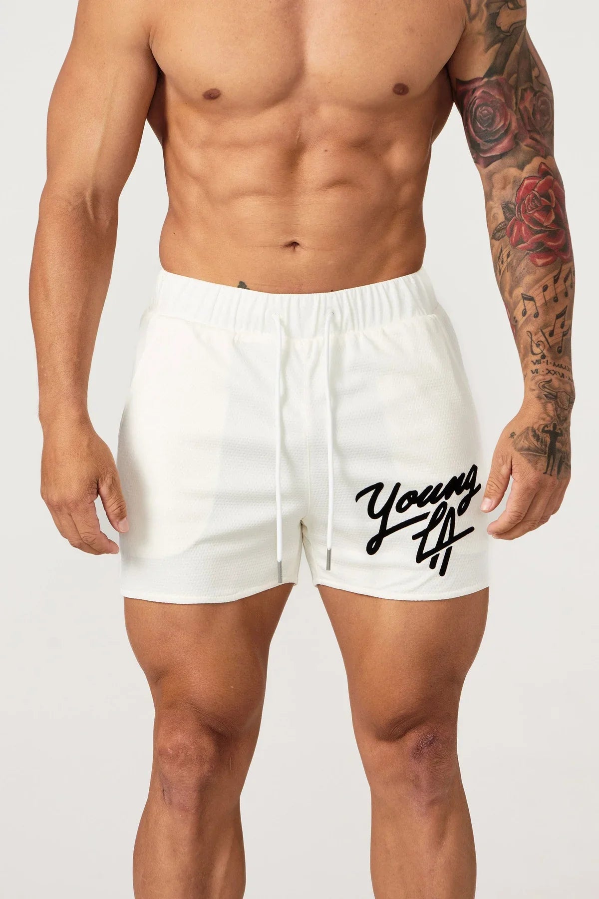 Young LA Trendy Beach Shorts for men featuring vibrant prints and elastic waist for comfort, perfect for summer activities.