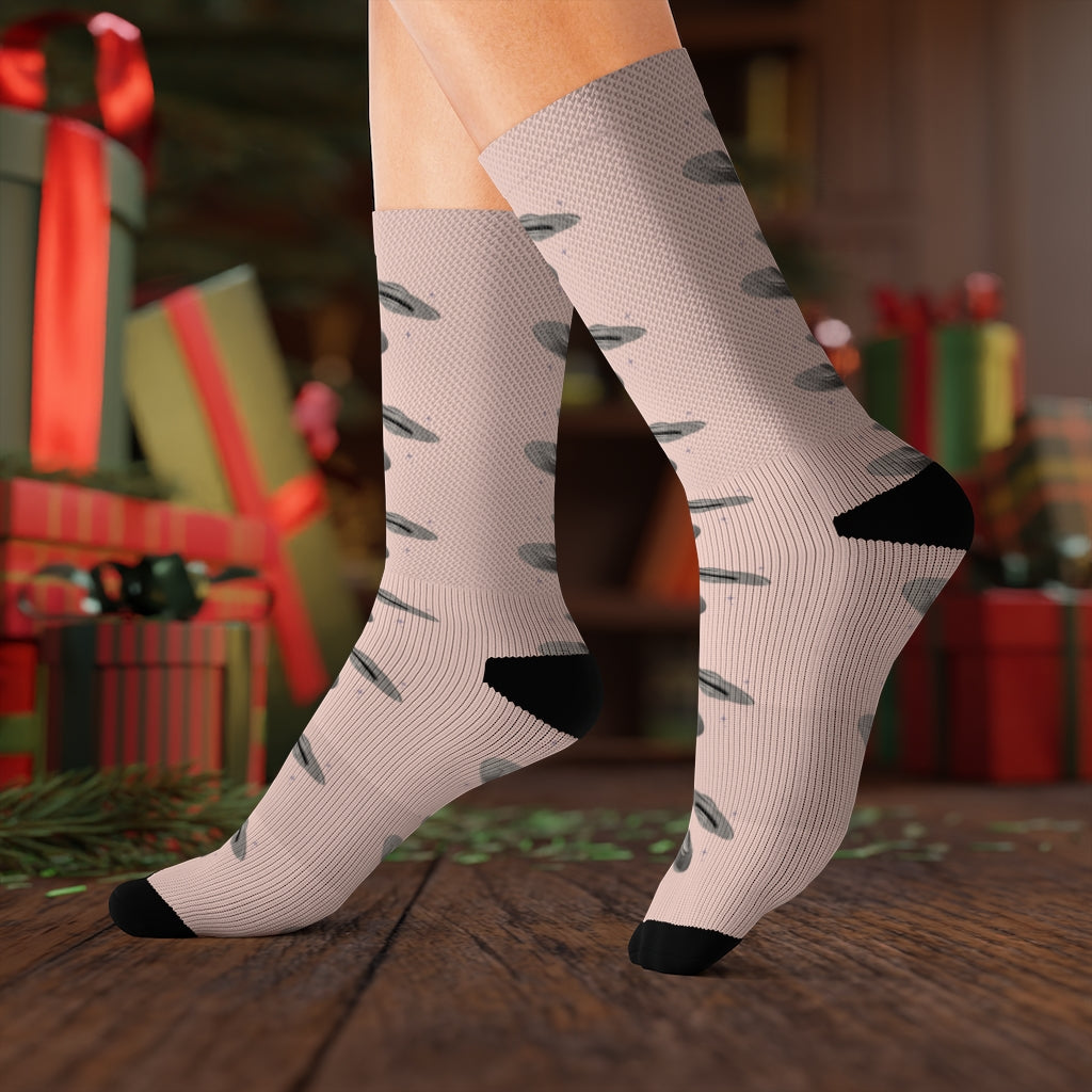 A pair of pink novelty socks featuring a fun UFO print, showcasing vibrant colors and a unique design, perfect for casual or office wear.