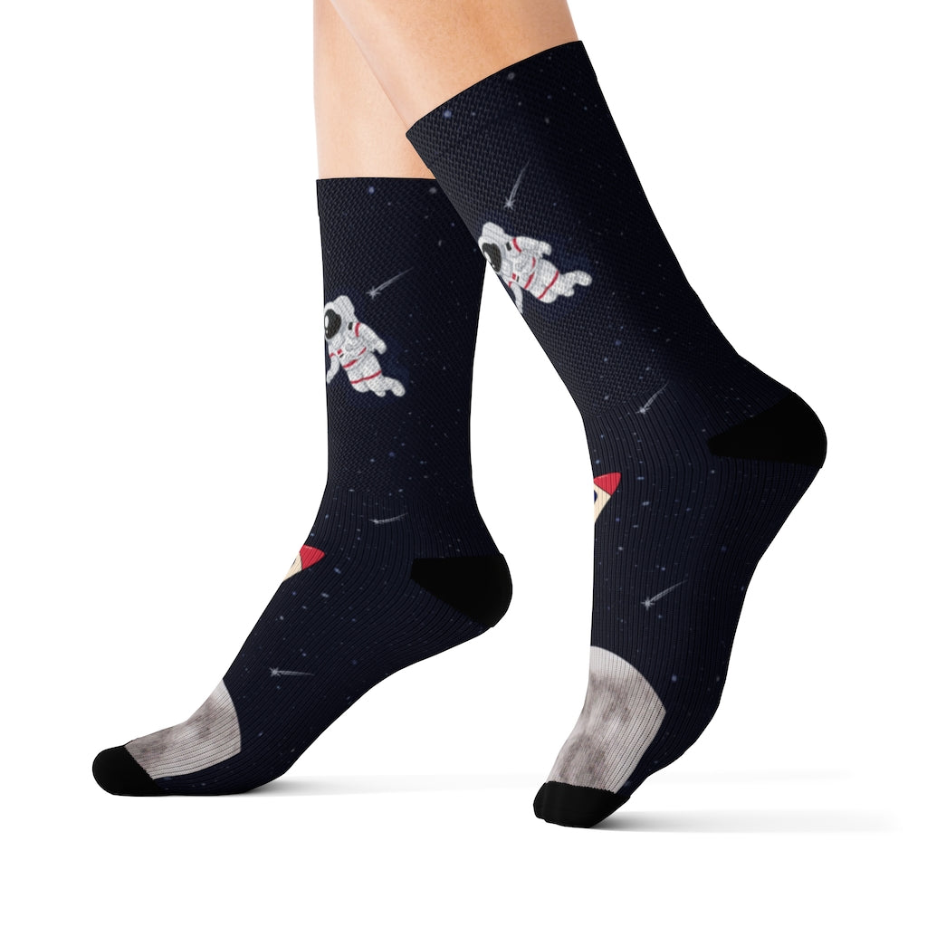 A pair of Astronaut and Space Funny Novelty Socks featuring a colorful astronaut print against a starry background, showcasing their unique design.