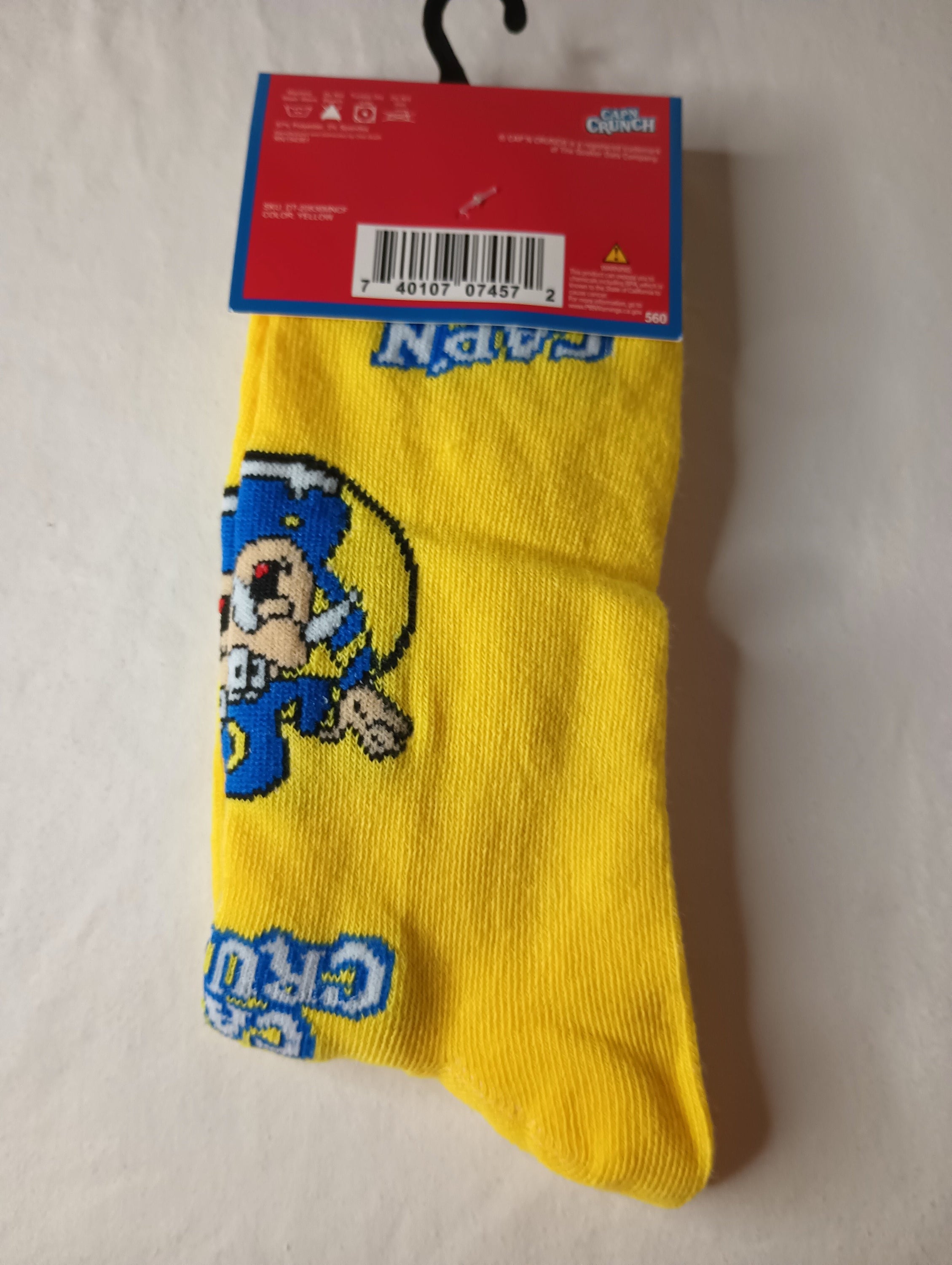 Cap'n Crunch Crew Socks in vibrant yellow and blue colors, designed for men's shoe sizes 6-12, made from polyester and spandex.