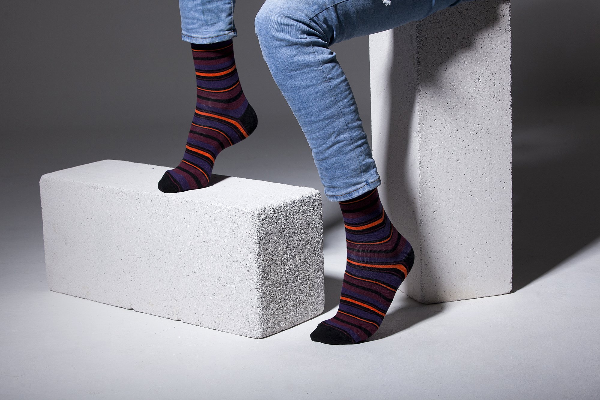 Men's Garnet Stripe Socks featuring vibrant colors and trendy patterns, perfect for adding style to any outfit.
