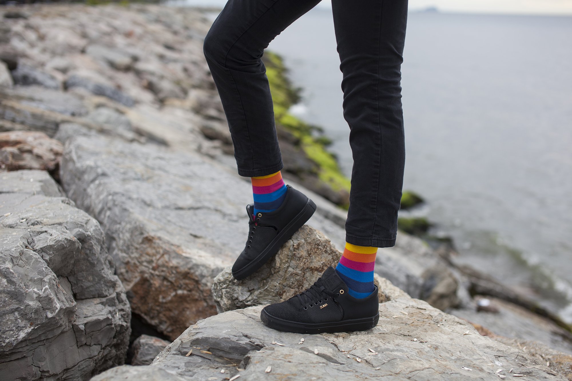 A collection of colorful men's striped socks displayed in a luxurious gift box, showcasing their trendy designs and premium quality.