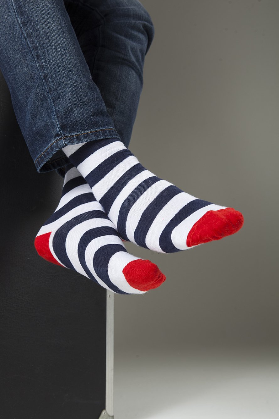 A collection of colorful men's striped socks displayed in a luxurious gift box, showcasing their trendy designs and premium quality.