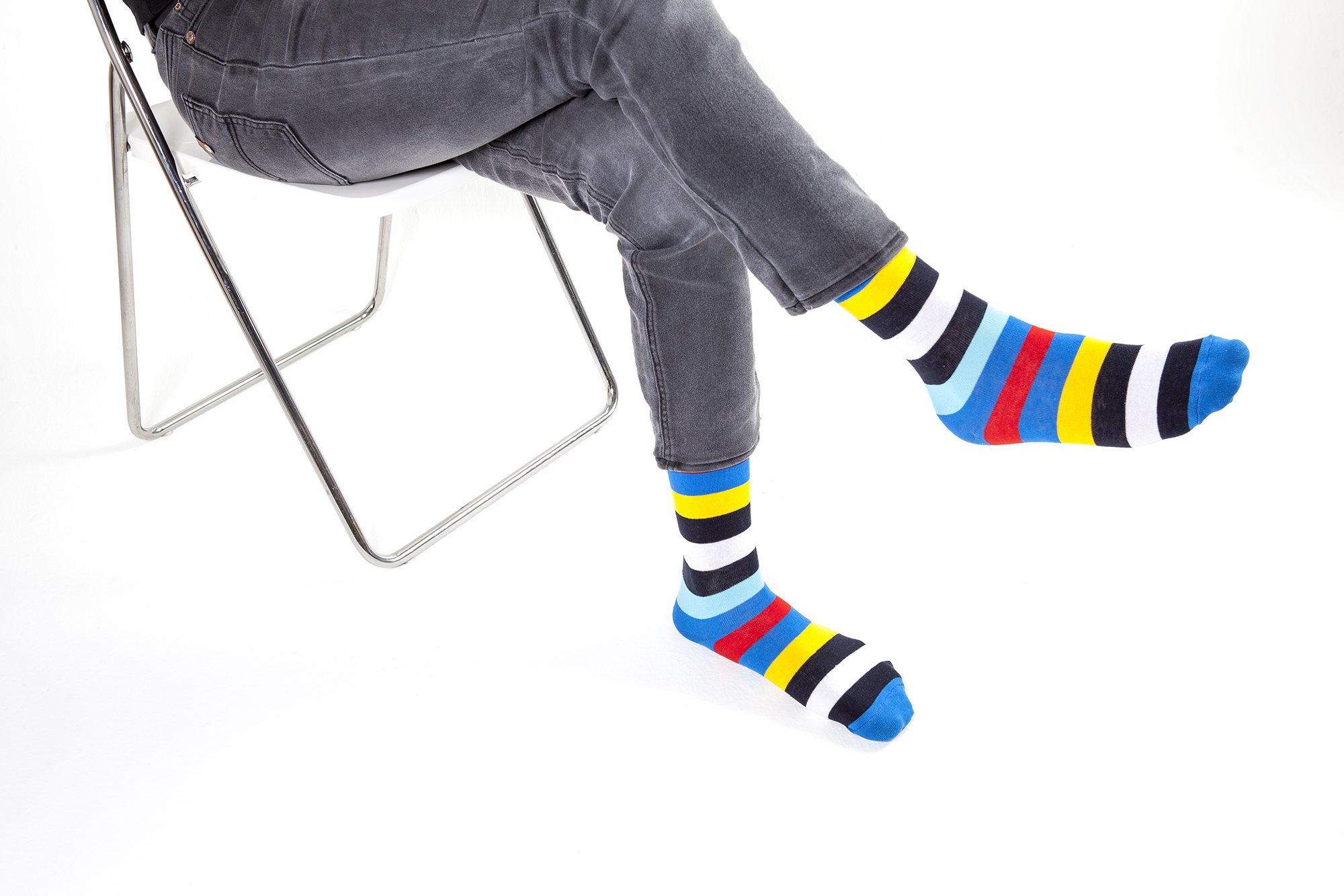 A collection of colorful men's striped socks displayed in a luxurious gift box, showcasing their trendy designs and premium quality.