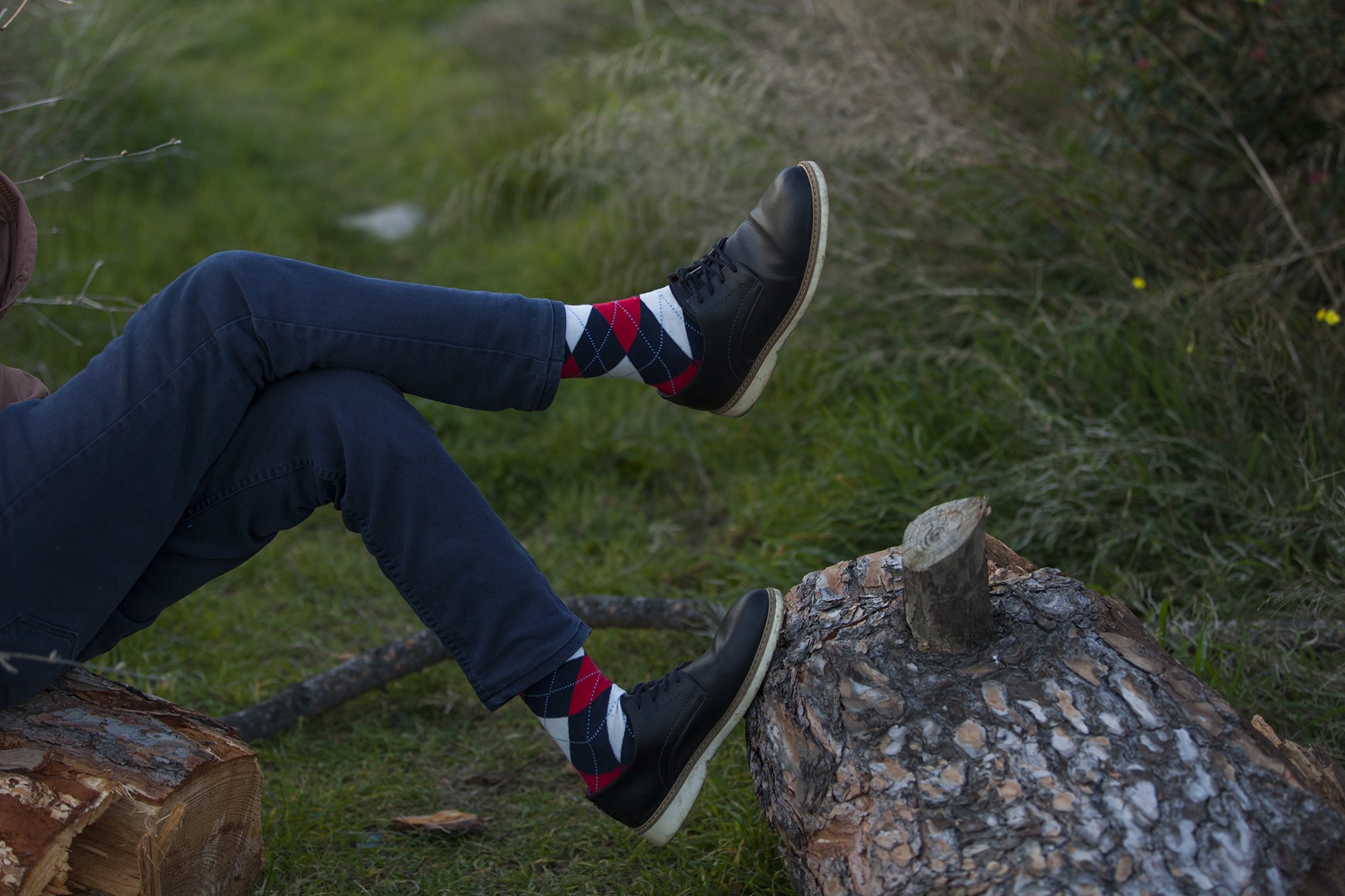 A collection of colorful and trendy men's dress socks in a luxurious gift box, showcasing various patterns and designs.