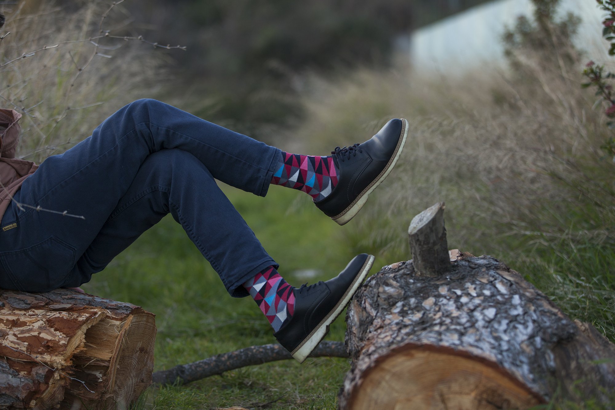 A collection of colorful and trendy men's dress socks in a luxurious gift box, showcasing various patterns and designs.