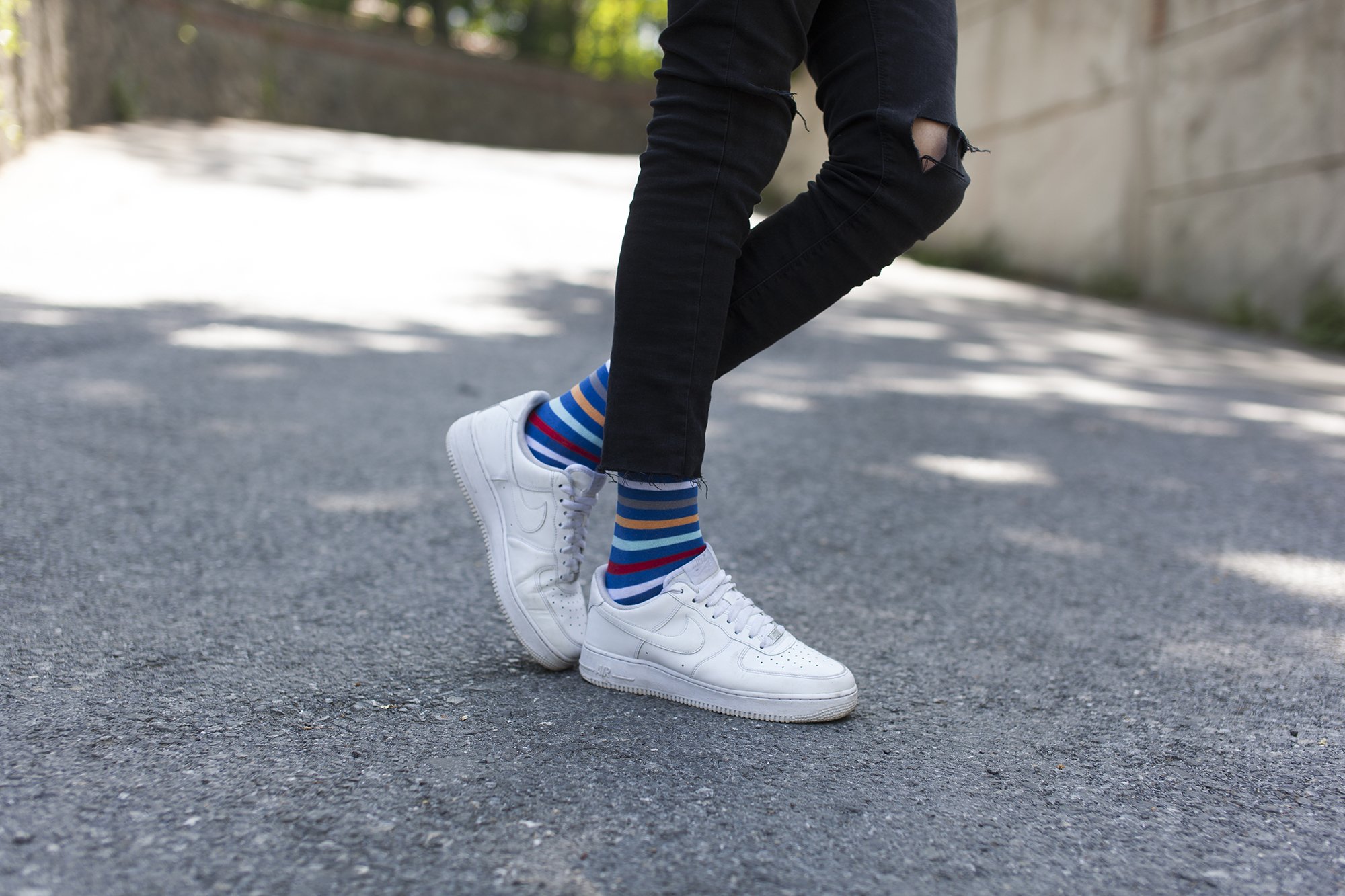 A collection of colorful and trendy men's dress socks in a luxurious gift box, showcasing various patterns and designs.