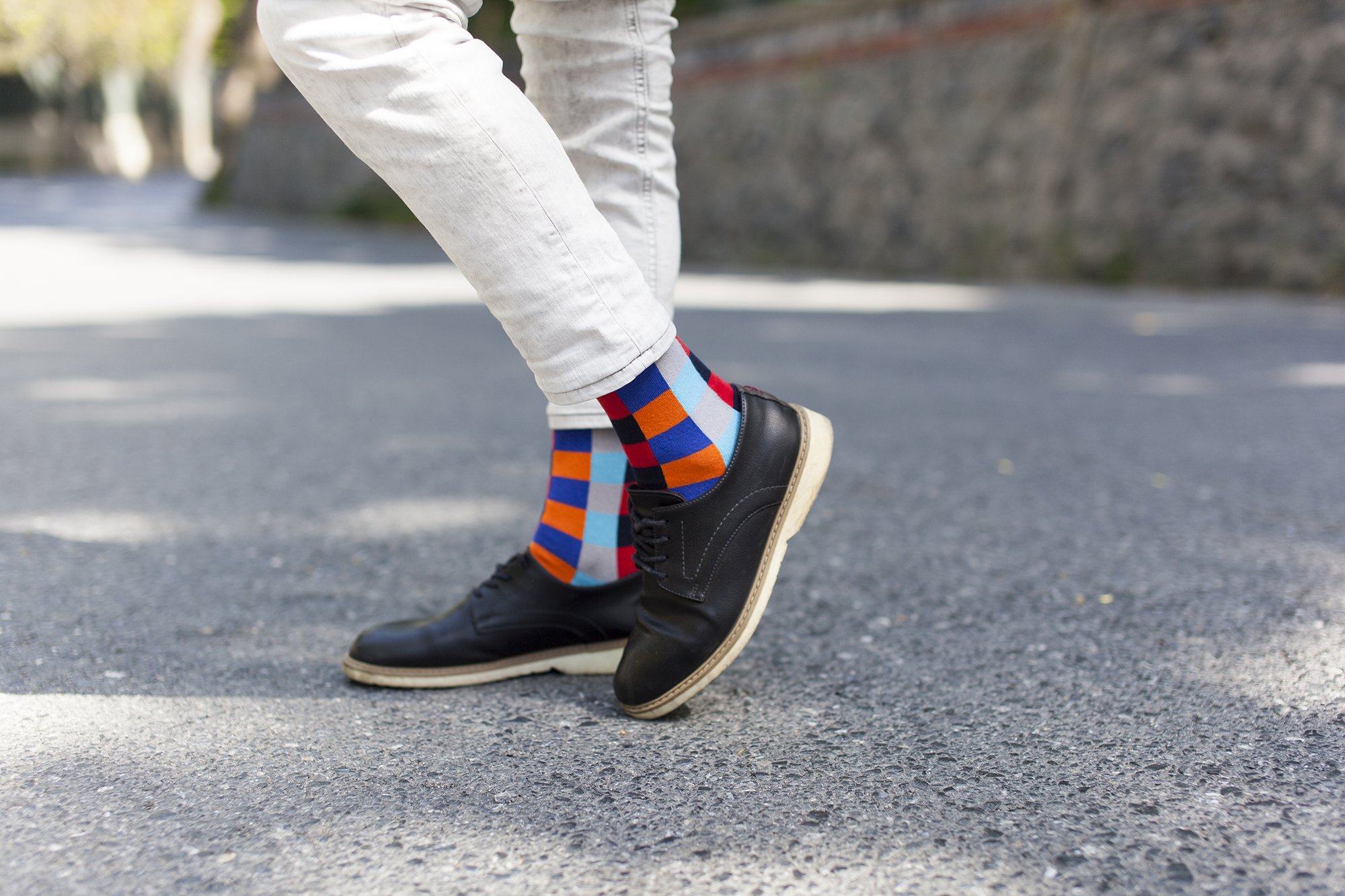A collection of colorful and trendy men's dress socks in a luxurious gift box, showcasing various patterns and designs.
