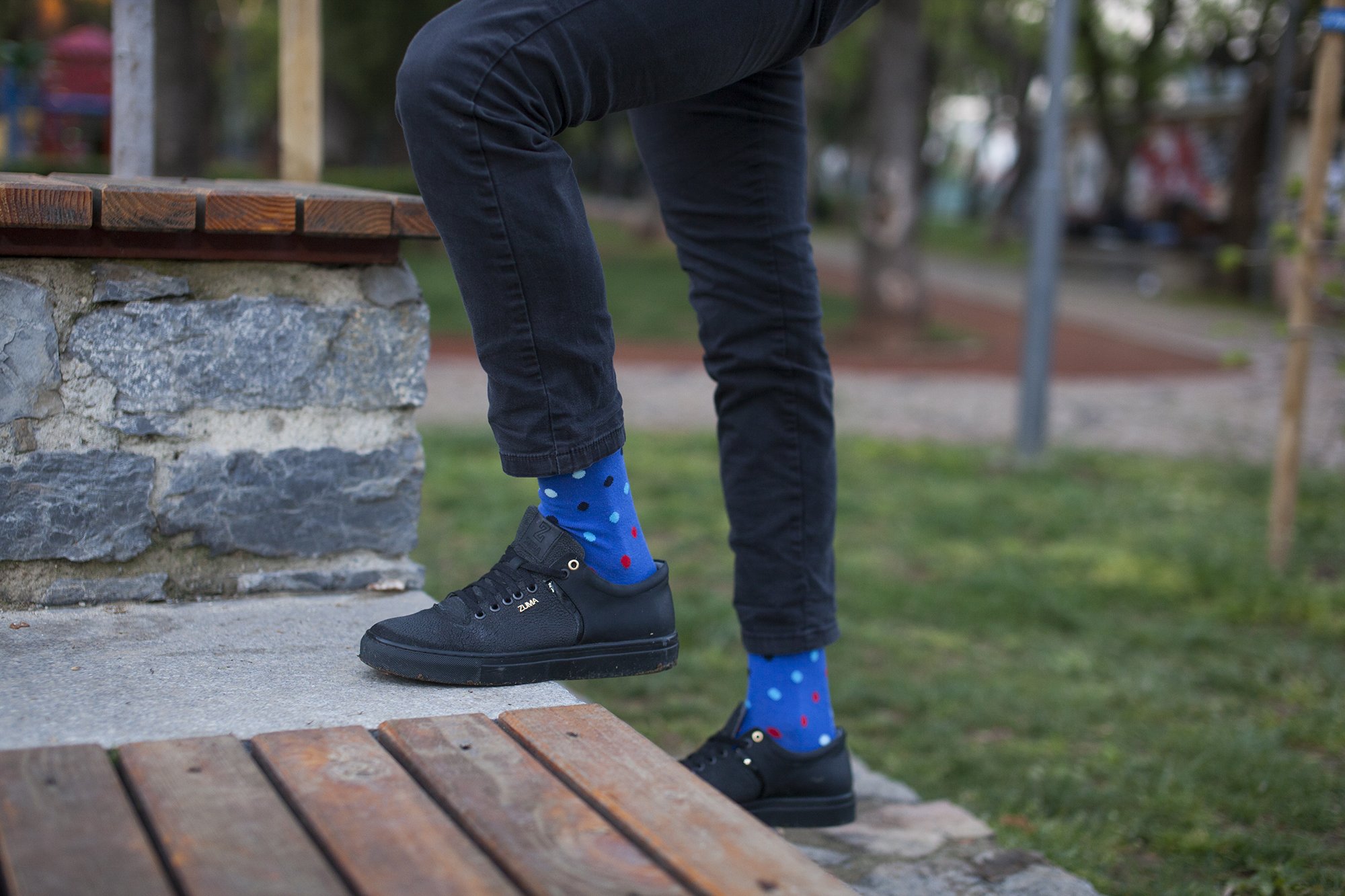 A collection of colorful and trendy men's dress socks in a luxurious gift box, showcasing various patterns and designs.