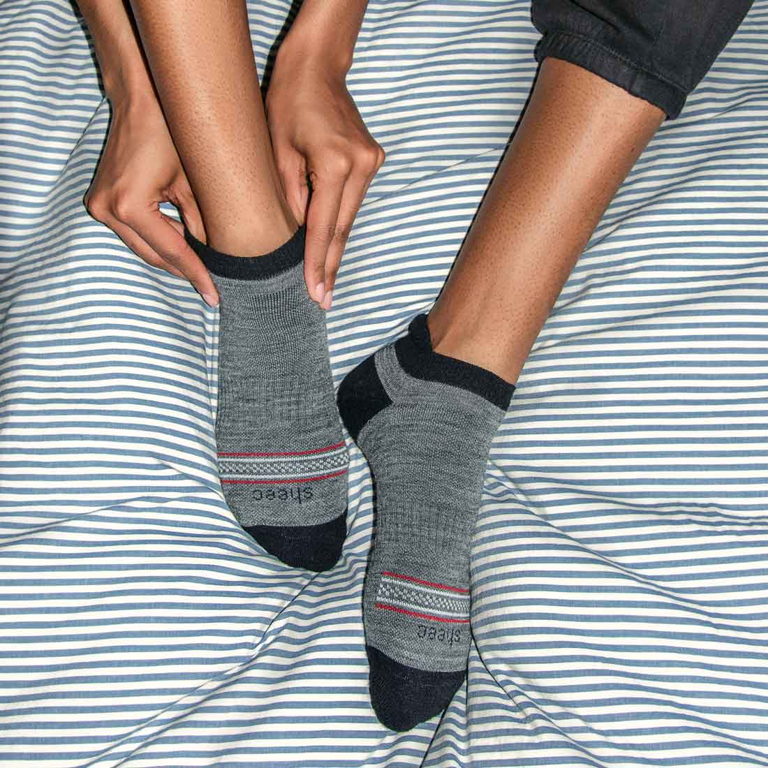 Dark gray Merino wool no show socks with blister tab, designed for comfort and protection.
