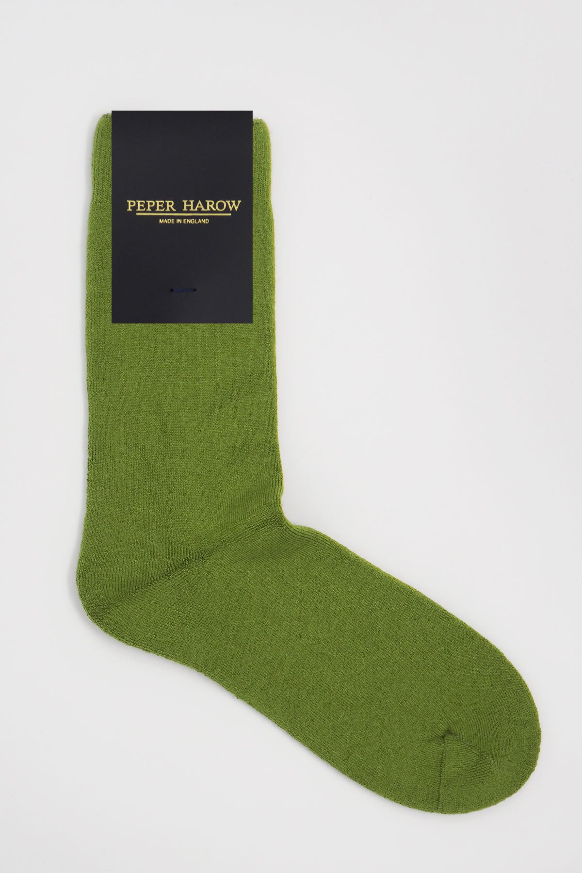 A pair of luxurious green women's bed socks made from soft Supima cotton, showcasing their fluffy interior and seamless toe design.