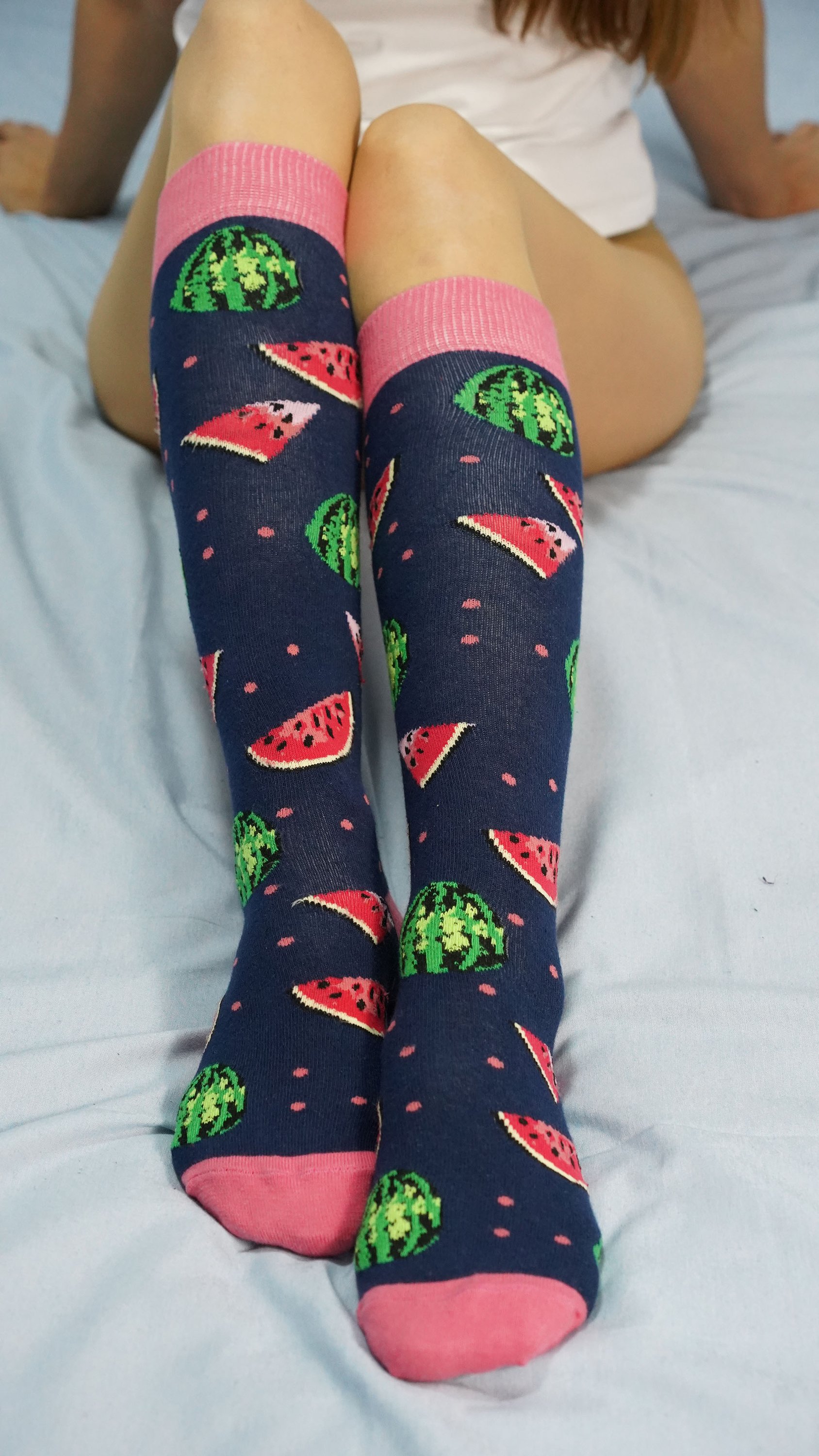 A vibrant set of Women's Delightful Fruits Knee High Socks featuring colorful fruit patterns, perfect for adding style and comfort to any outfit.