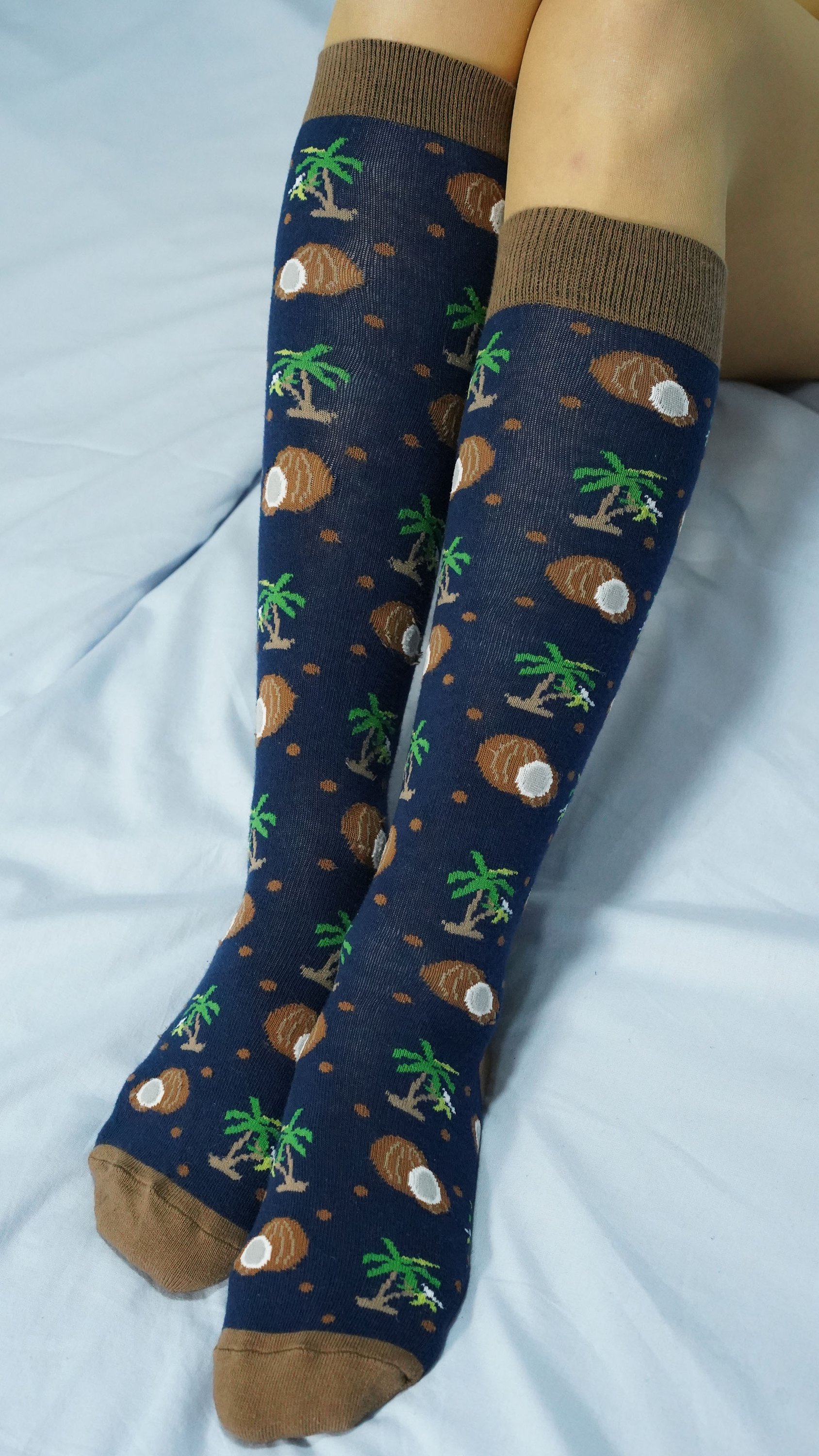 A vibrant set of Women's Delightful Fruits Knee High Socks featuring colorful fruit patterns, perfect for adding style and comfort to any outfit.
