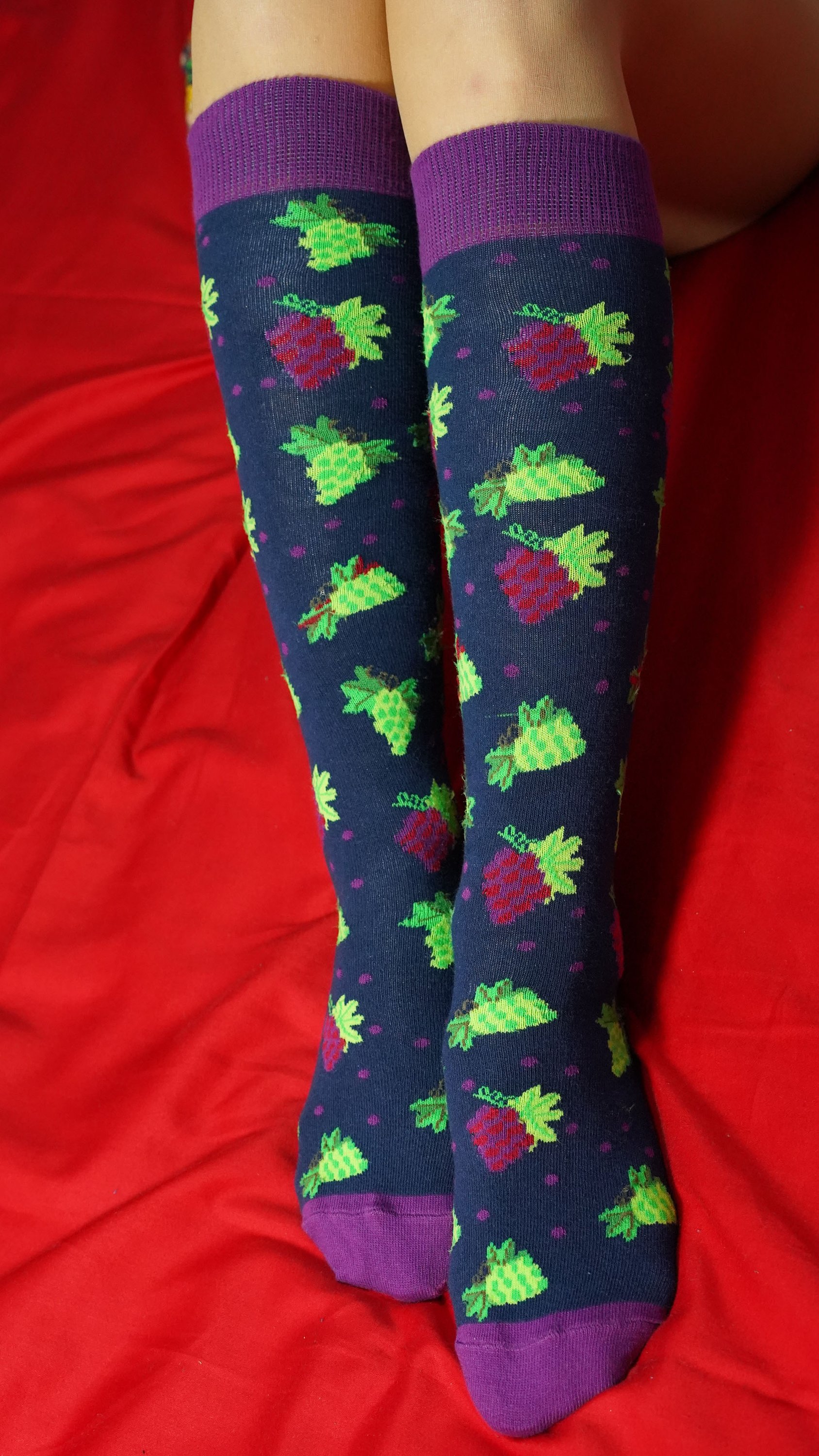 A vibrant set of Women's Delightful Fruits Knee High Socks featuring colorful fruit patterns, perfect for adding style and comfort to any outfit.