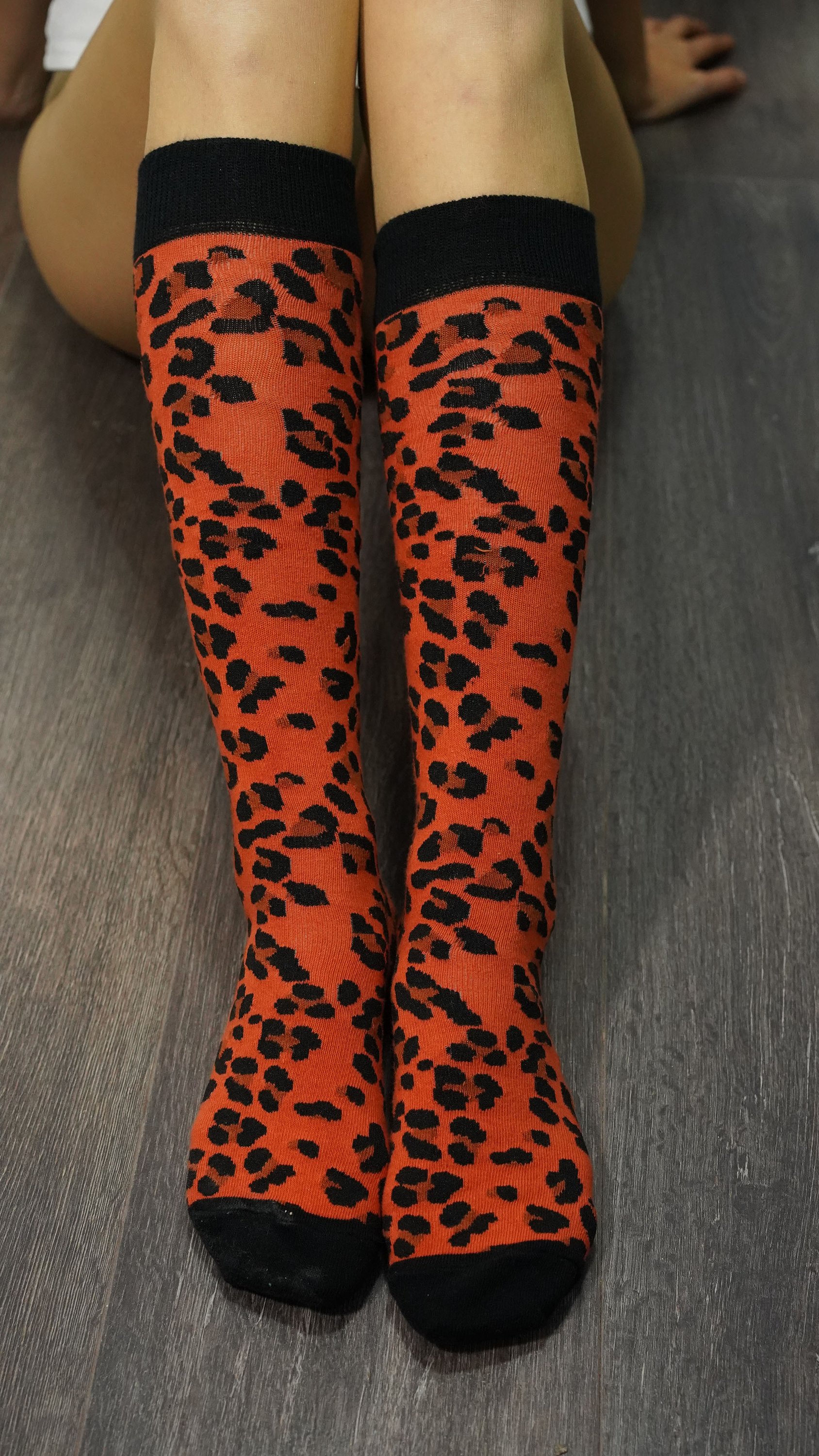 A pair of stylish Women's Leopard Knee High Socks featuring a trendy leopard print design, perfect for adding flair to any outfit.