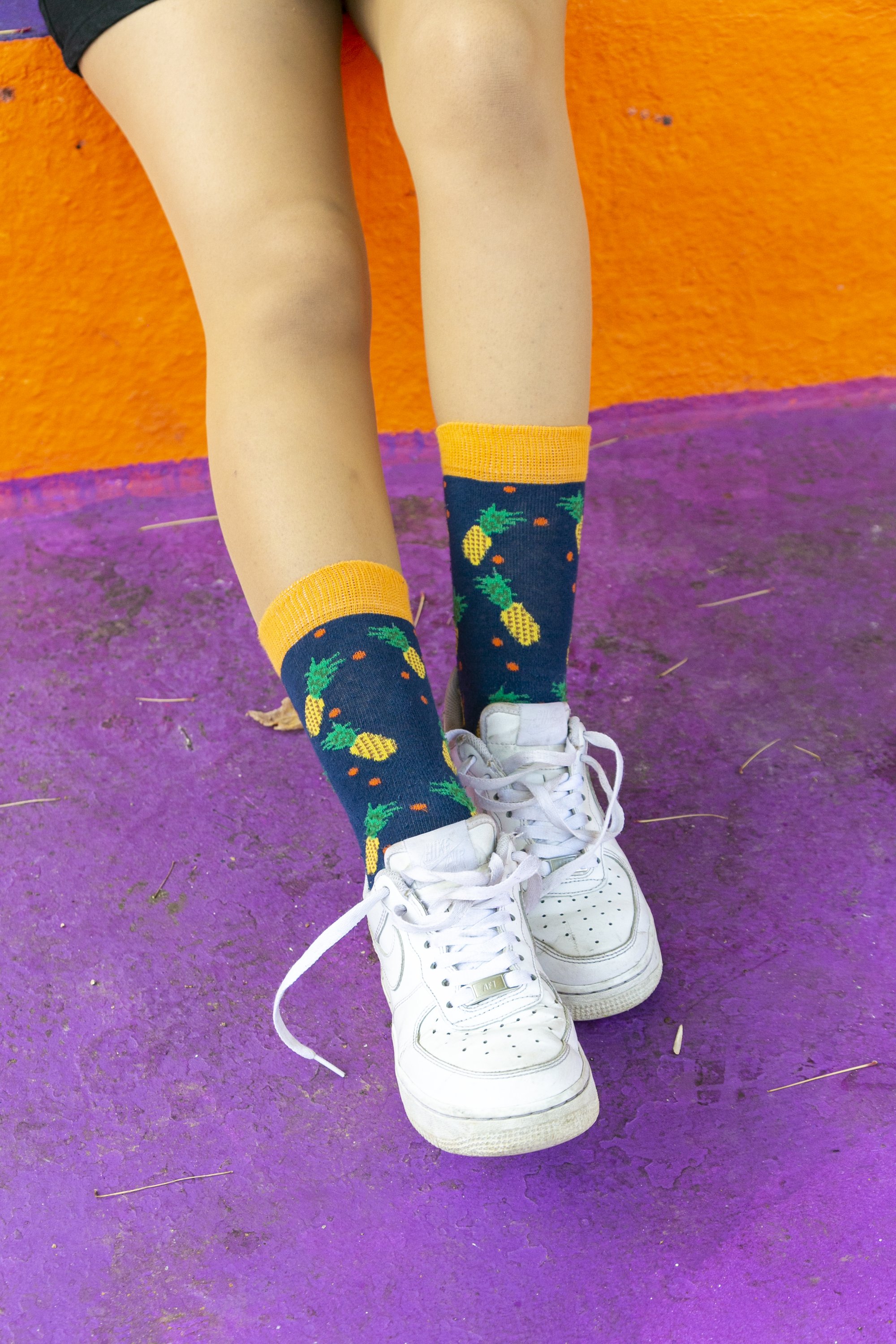 A pair of colorful women's pineapple socks made from soft cotton, featuring a vibrant pineapple pattern.