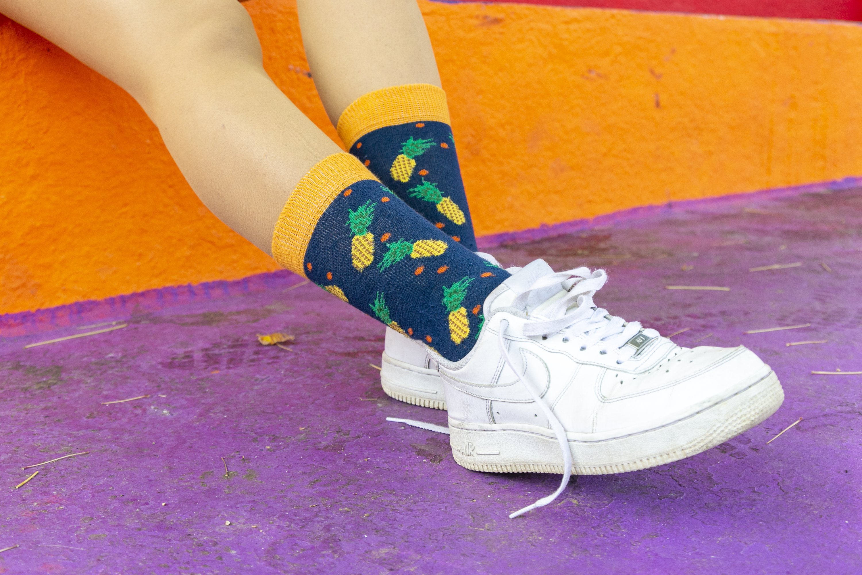 A pair of colorful women's pineapple socks made from soft cotton, featuring a vibrant pineapple pattern.