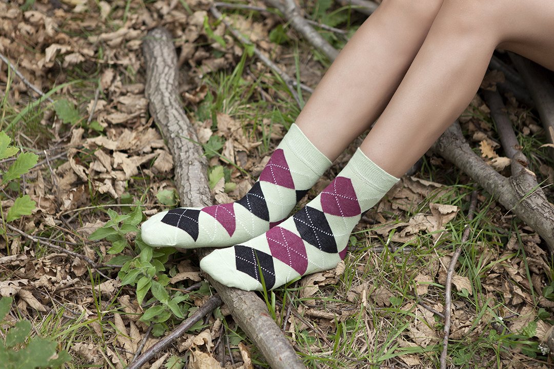 A pair of Women's Pistachio Argyle Socks featuring a vibrant green color and trendy argyle pattern, perfect for adding style to any outfit.
