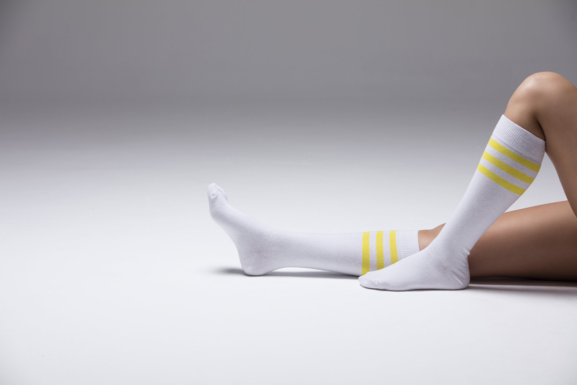 A vibrant set of Women's Solid Stripe Knee High Socks featuring colorful patterns and a comfortable fit, perfect for stylish outfits.