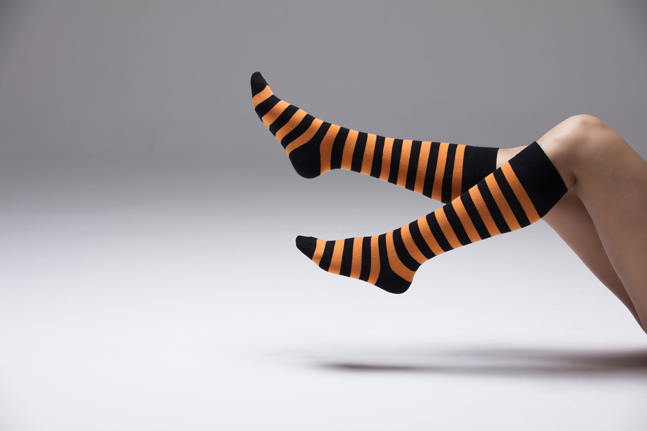 A vibrant set of women's knee-high socks featuring stylish stripes in various colors, perfect for adding flair to any outfit.