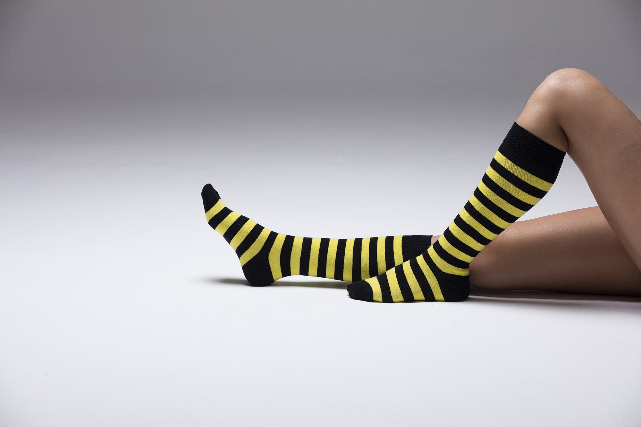 A vibrant set of women's knee-high socks featuring stylish stripes in various colors, perfect for adding flair to any outfit.