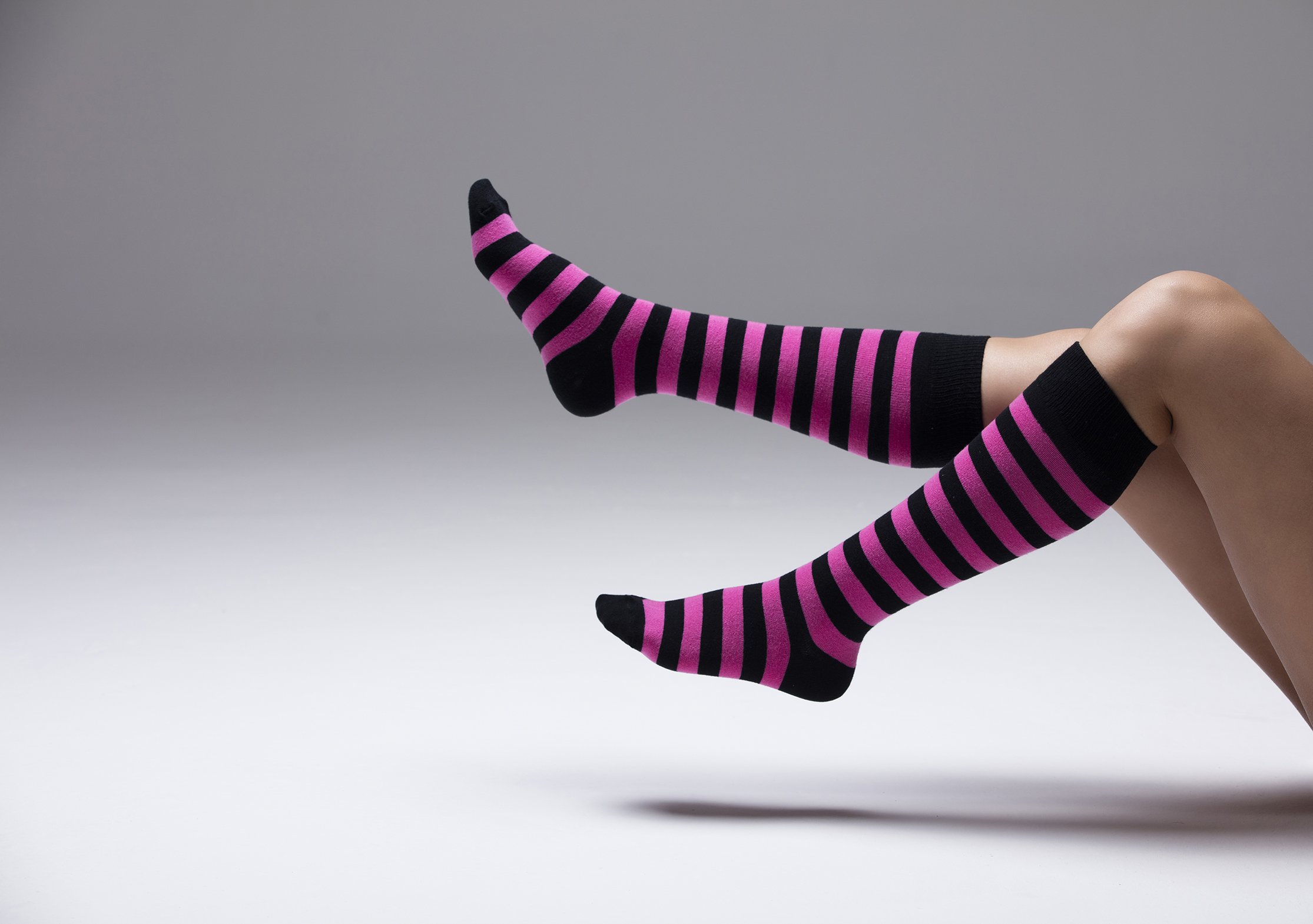 A vibrant set of women's knee-high socks featuring stylish stripes in various colors, perfect for adding flair to any outfit.