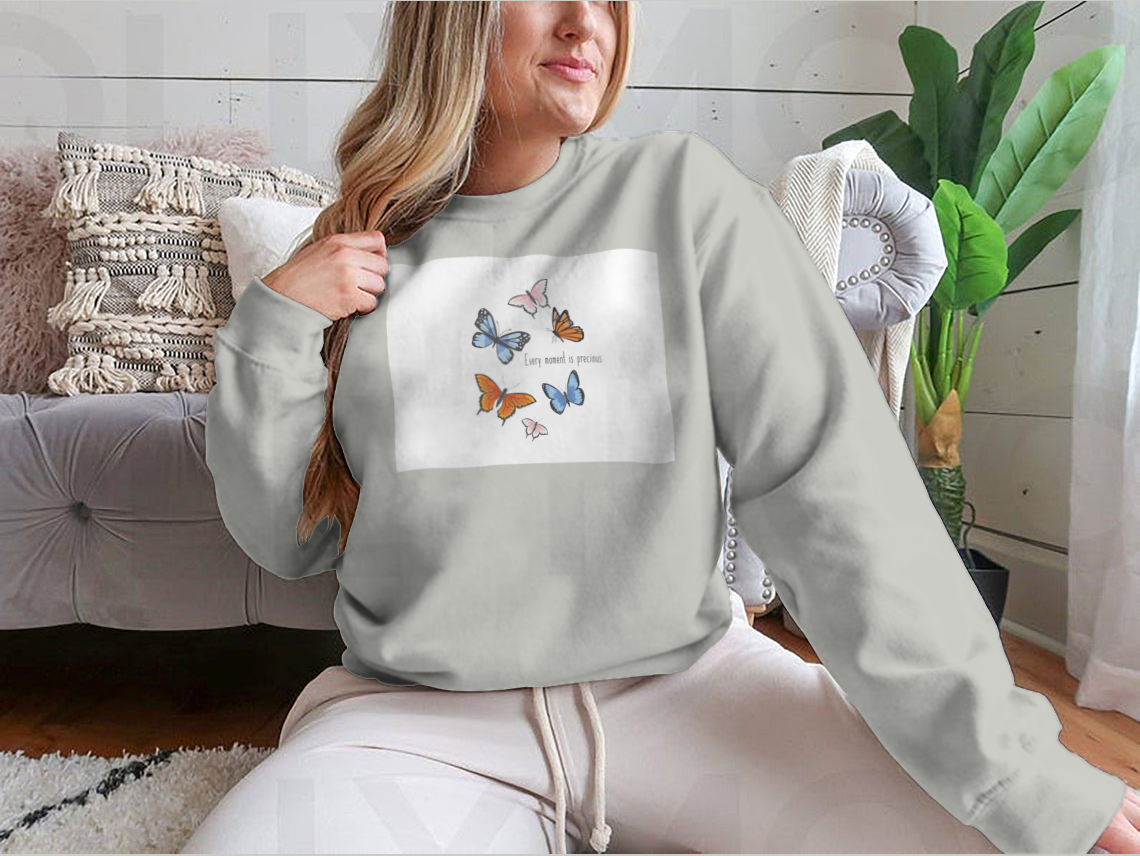 A vibrant sweatshirt featuring a colorful butterfly design, made from soft cotton fabric, showcasing a classic fit and midweight construction.