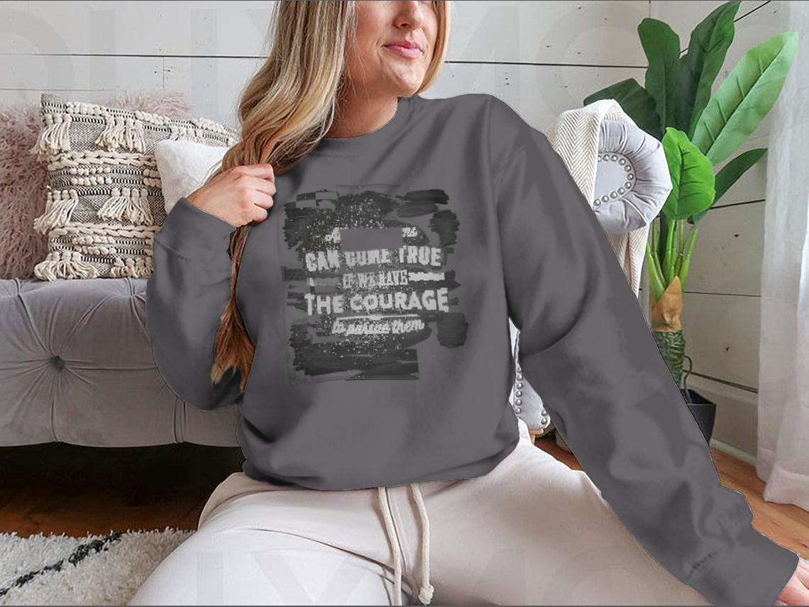 A motivational shirt featuring the quote 'All Our Dreams Can Come True If We Have The Courage To Pursue Them', made from a soft cotton/polyester blend.