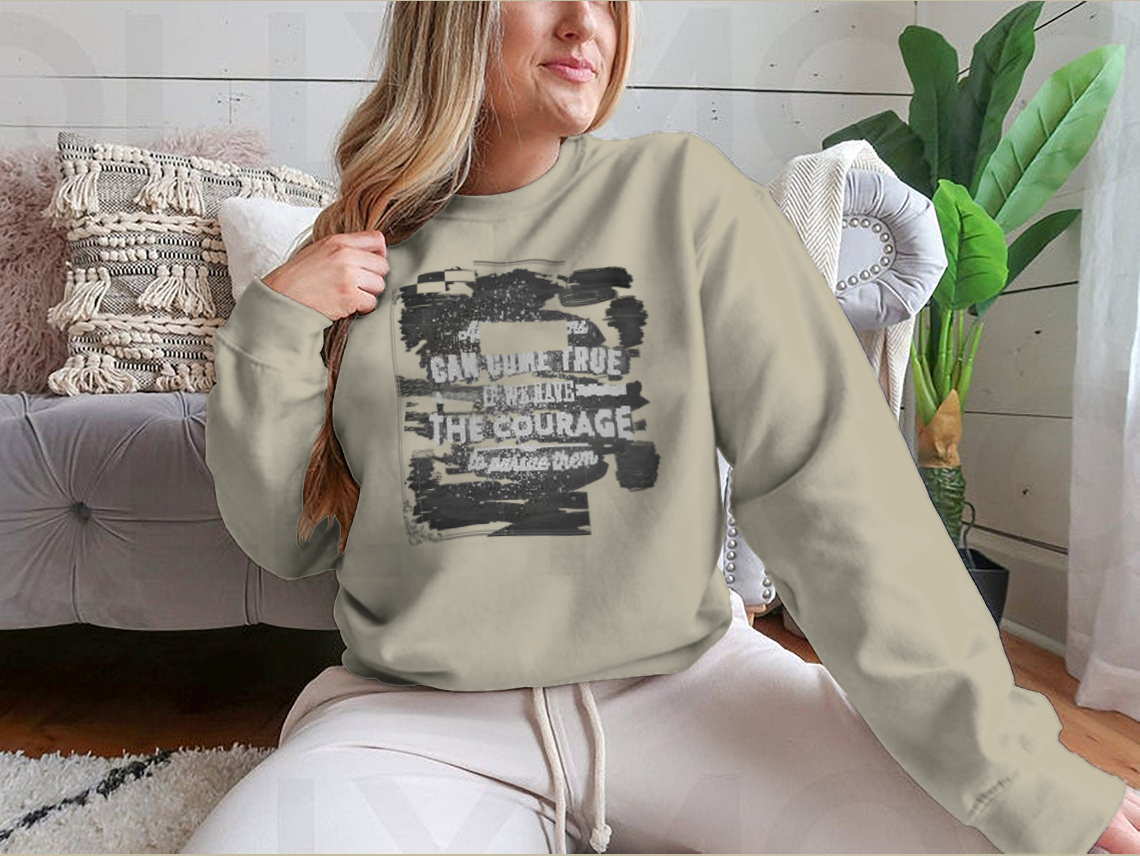 A motivational shirt featuring the quote 'All Our Dreams Can Come True If We Have The Courage To Pursue Them', made from a soft cotton/polyester blend.