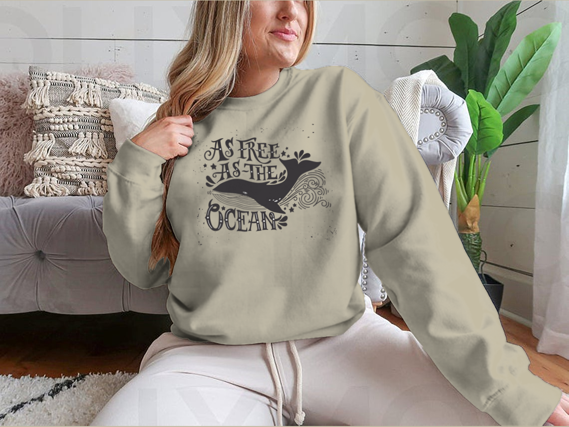 A cozy sweatshirt featuring the inspiring quote 'As Free As The Ocean' designed for comfort and style, perfect for casual wear.