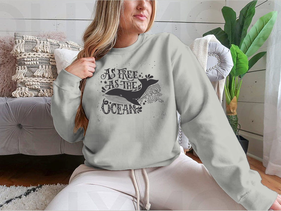 A cozy sweatshirt featuring the inspiring quote 'As Free As The Ocean' designed for comfort and style, perfect for casual wear.