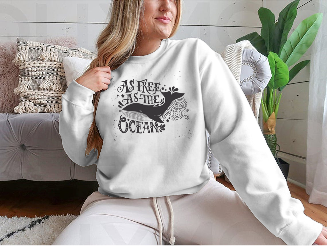 A cozy sweatshirt featuring the inspiring quote 'As Free As The Ocean' designed for comfort and style, perfect for casual wear.