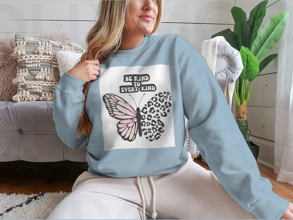 A cozy sweatshirt featuring the positive quote 'Be Kind To Every Kind' in stylish typography, showcasing its comfortable fabric and classic fit.