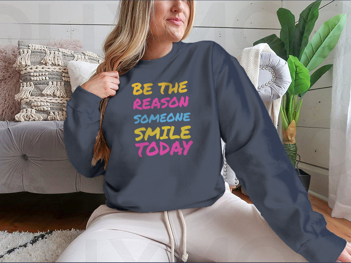 A stylish t-shirt featuring the phrase 'Be The Reason Someone Smile Today', made from 100% cotton, showcasing a classic fit and midweight fabric.