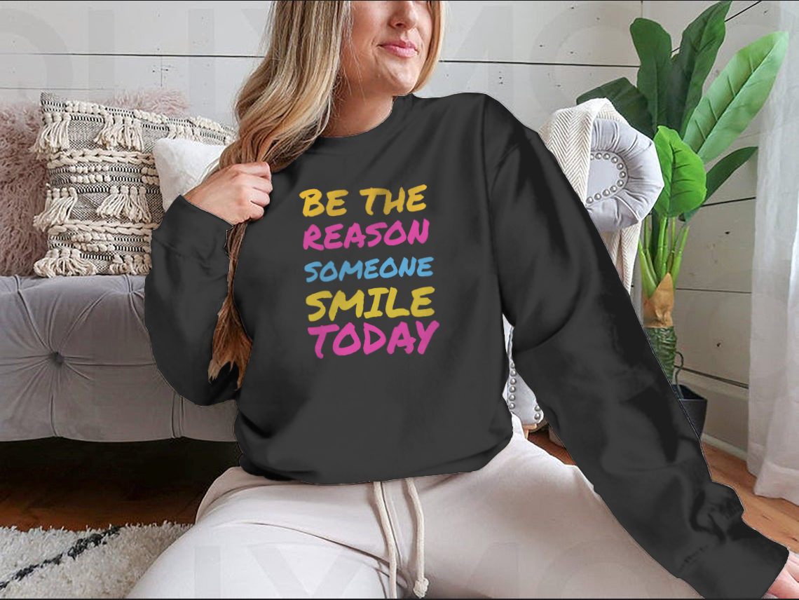 A stylish t-shirt featuring the phrase 'Be The Reason Someone Smile Today', made from 100% cotton, showcasing a classic fit and midweight fabric.