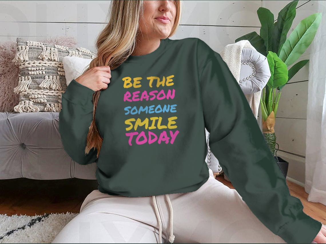 A stylish t-shirt featuring the phrase 'Be The Reason Someone Smile Today', made from 100% cotton, showcasing a classic fit and midweight fabric.