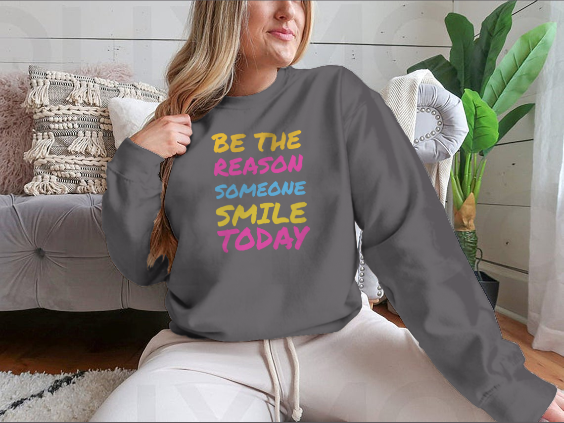 A stylish t-shirt featuring the phrase 'Be The Reason Someone Smile Today', made from 100% cotton, showcasing a classic fit and midweight fabric.
