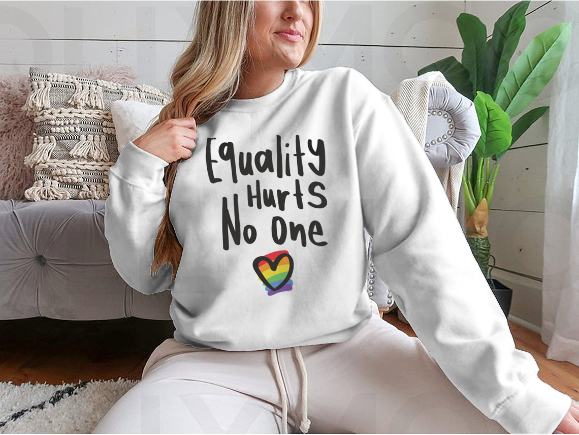 A cozy sweatshirt featuring an inspirational quote about equality, designed for comfort and style.