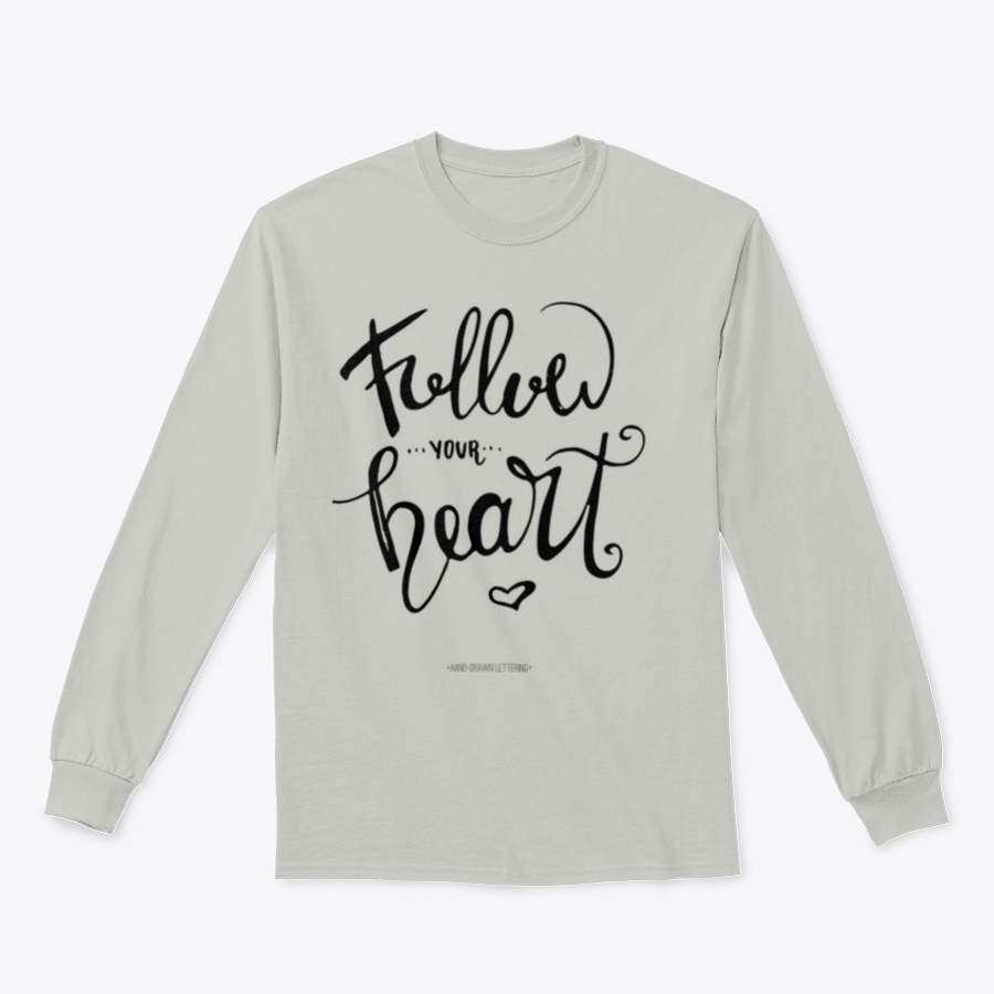 A stylish apparel featuring modern brush hand-drawn ink calligraphy saying 'Follow Your Heart' with a heart symbol, showcasing a blend of cotton and polyester.